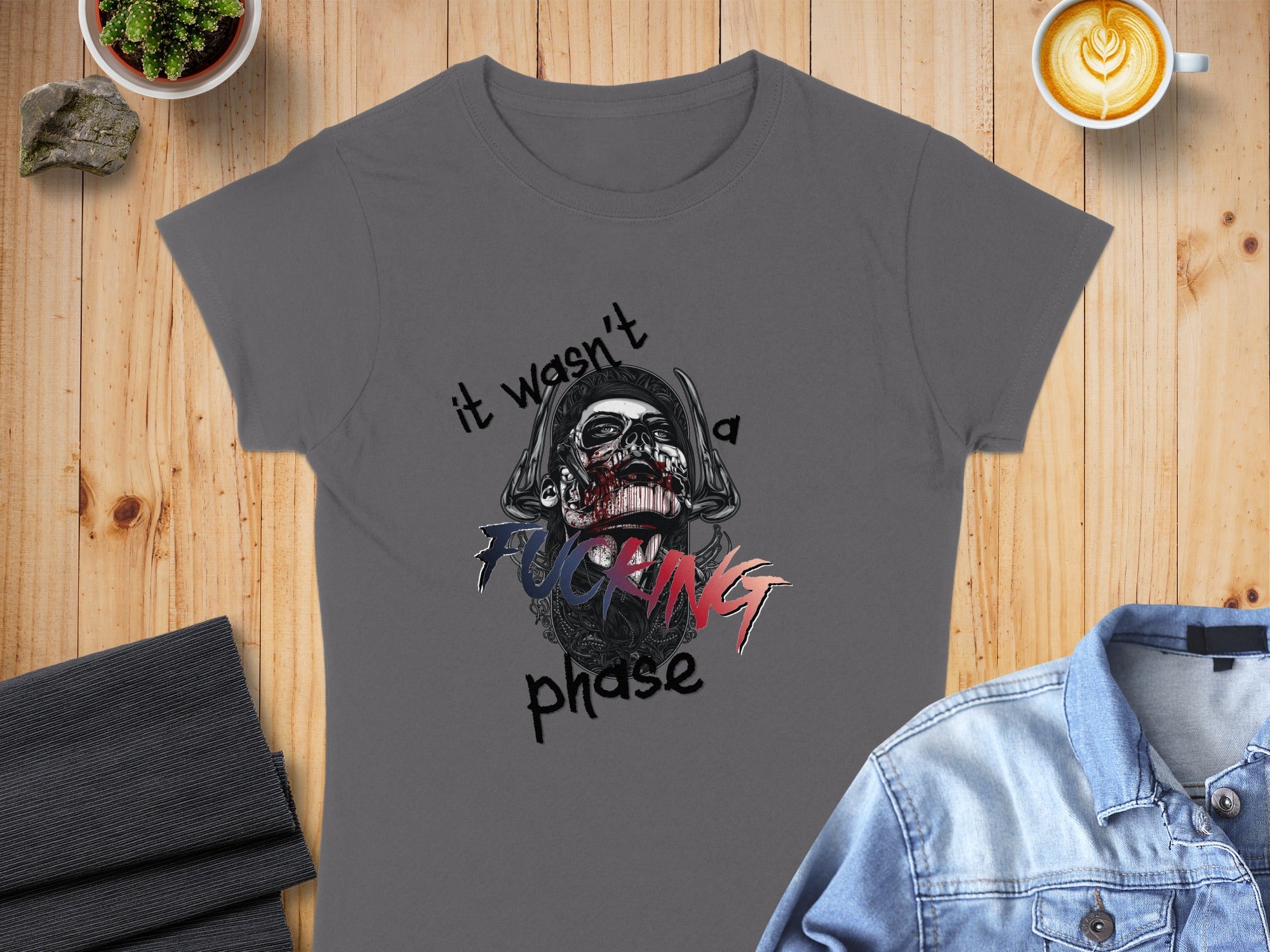 Gray t-shirt with "it wasn't a fucking phase" skull graphic.