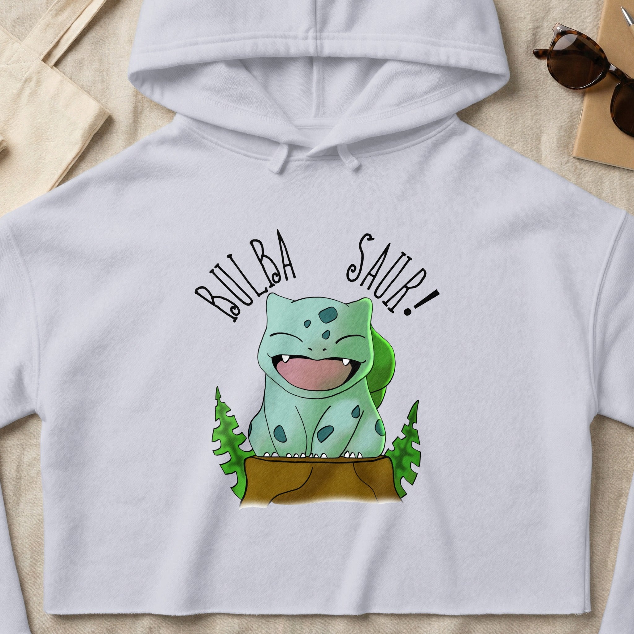 Bulbasaur character on a white cropped hoodie, "Bulba Saur!" text above.
