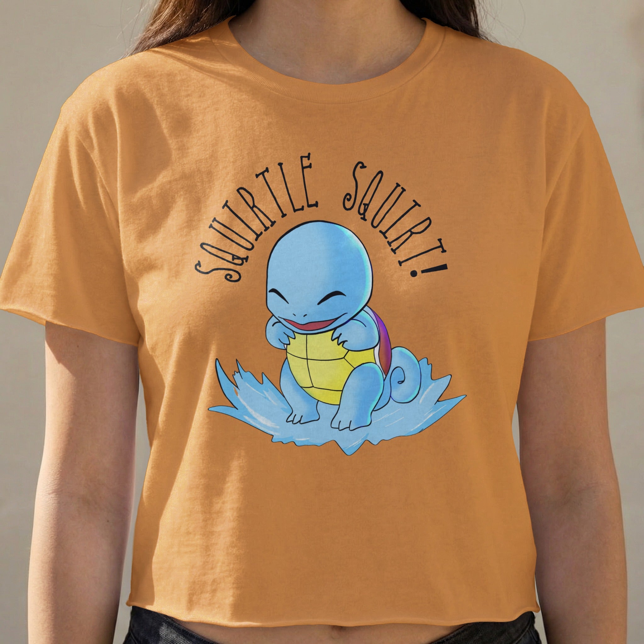 Squirtle graphic and text "Squirtle Squirt!" on an orange t-shirt.