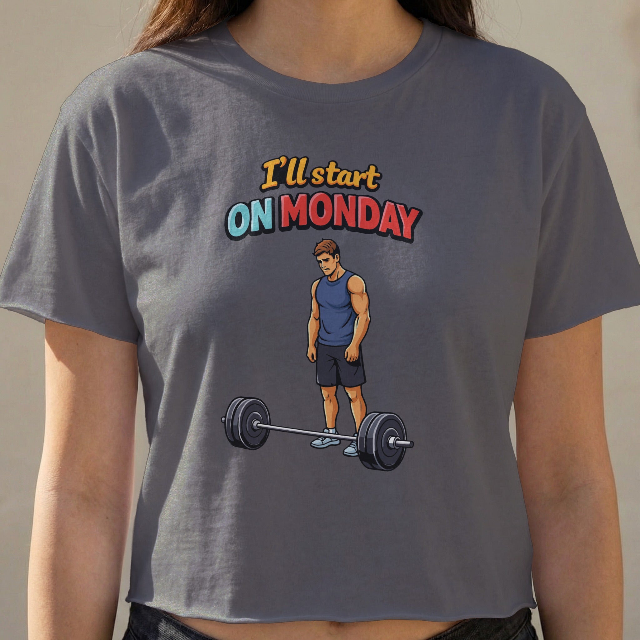 Gray t-shirt with a graphic of a man standing by a barbell and text "I'll start ON MONDAY".