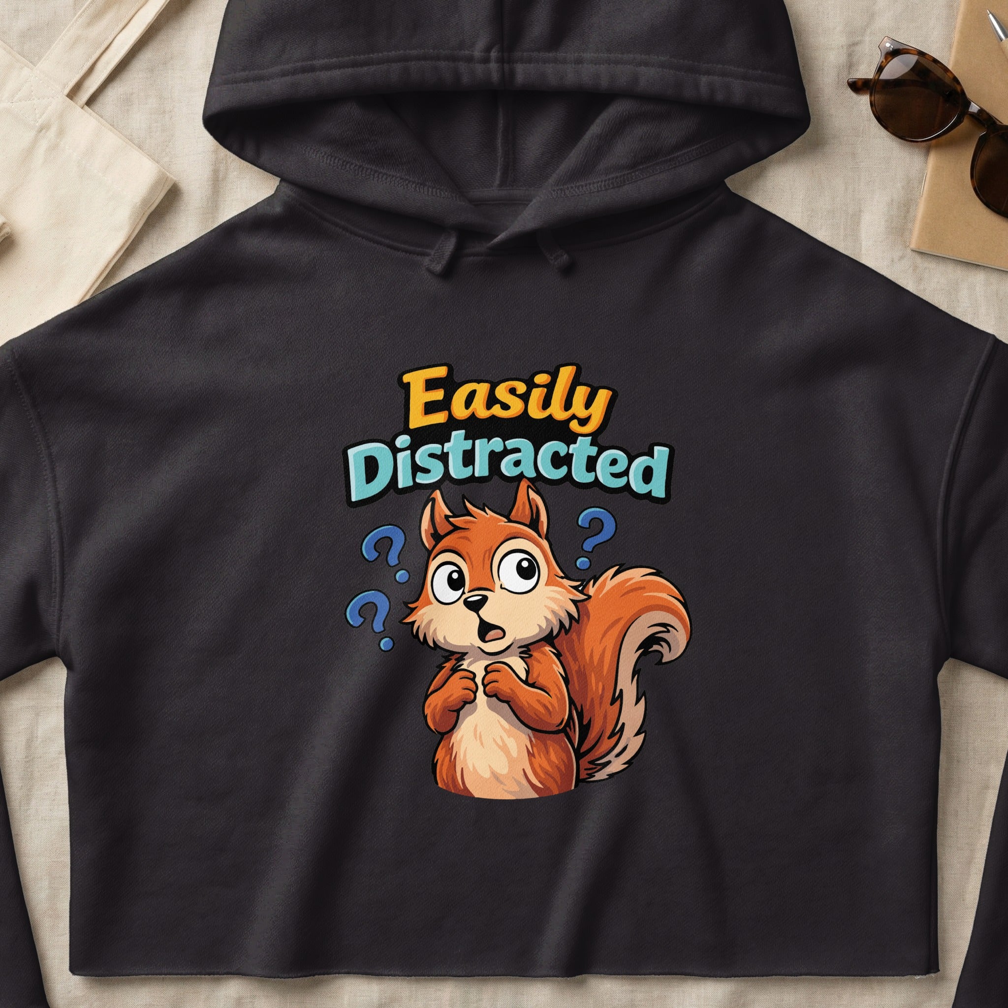 Black hoodie with cartoon squirrel and "Easily Distracted" text.