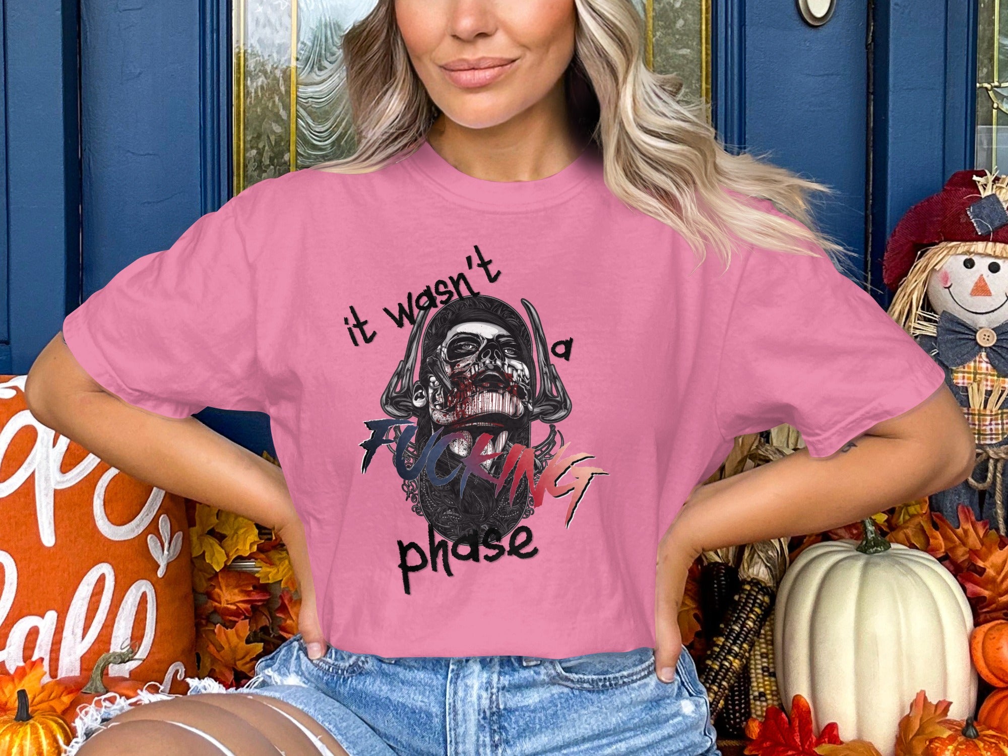 Pink t-shirt with skull graphic and text "it wasn't a phase".