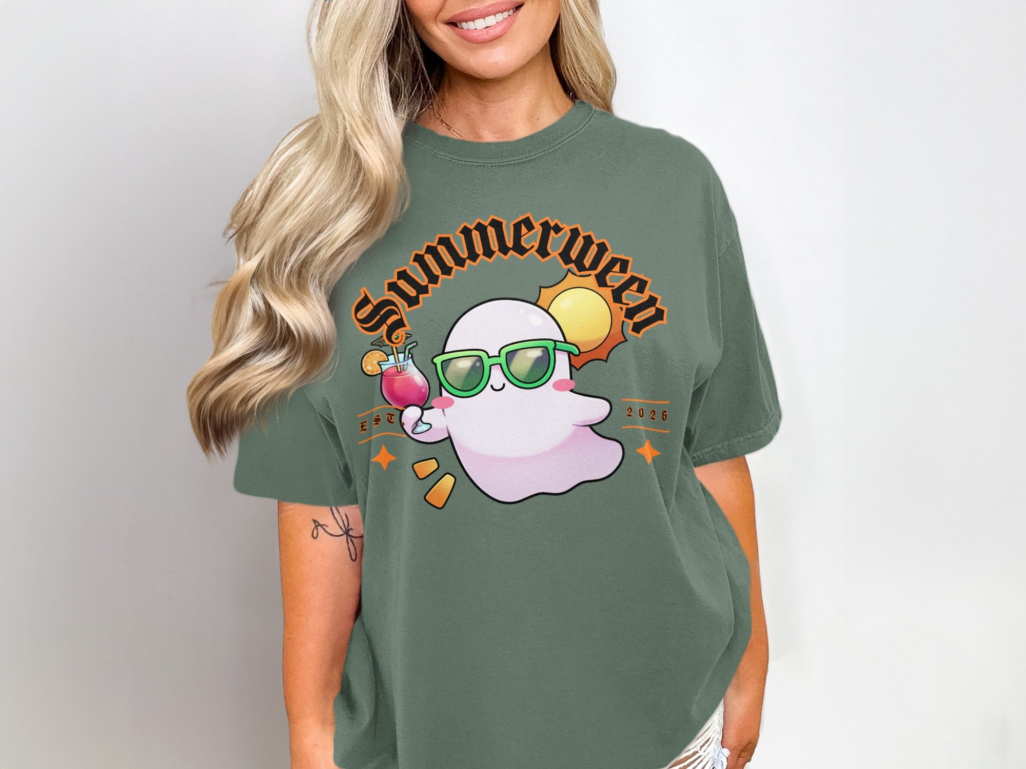 Green t-shirt with a "Summerween" ghost wearing sunglasses and holding a drink.