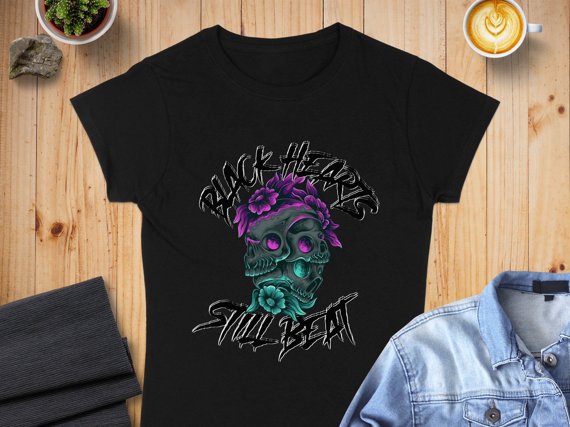 Black t-shirt with a skull design featuring floral accents and text.