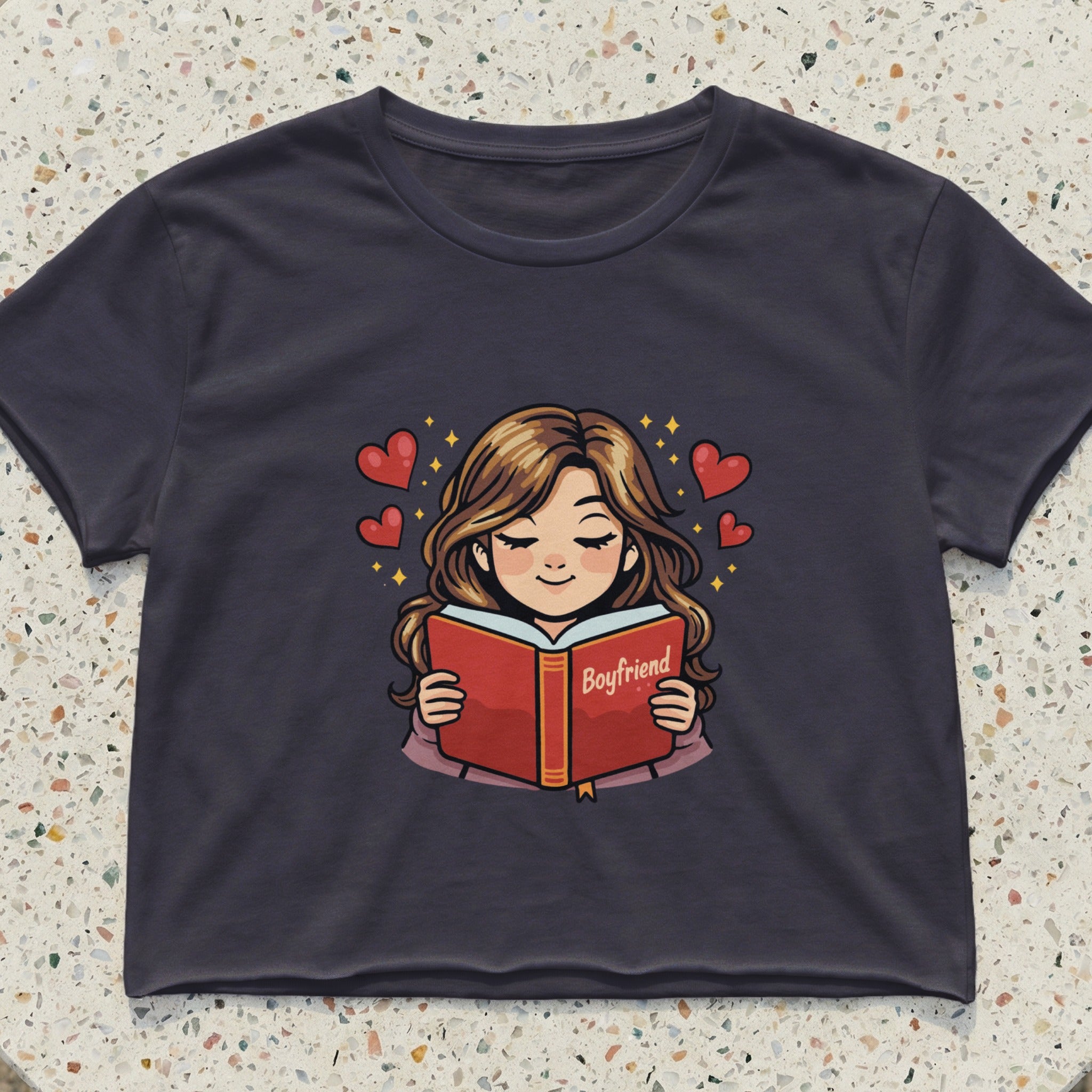 Cropped t-shirt with cartoon of girl reading a book titled "Boyfriend."