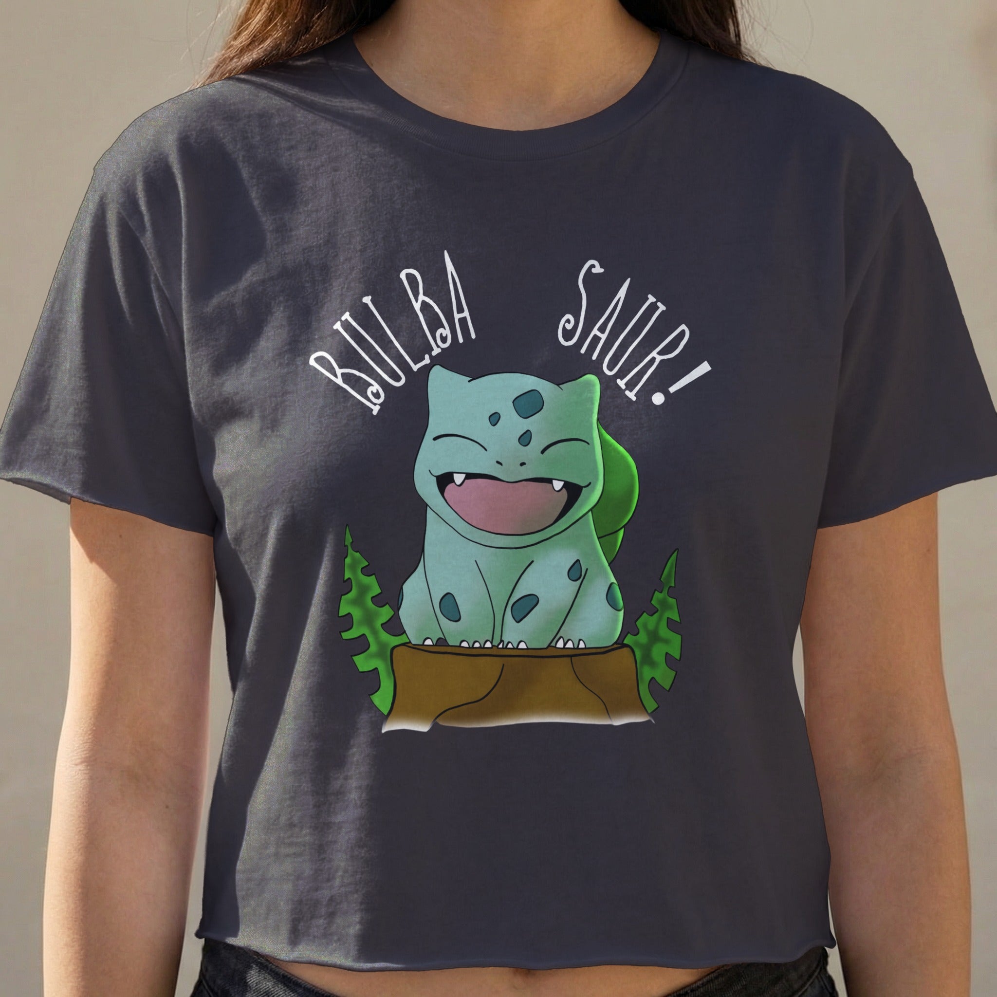 Bulbasaur graphic on a dark grey cropped t-shirt.