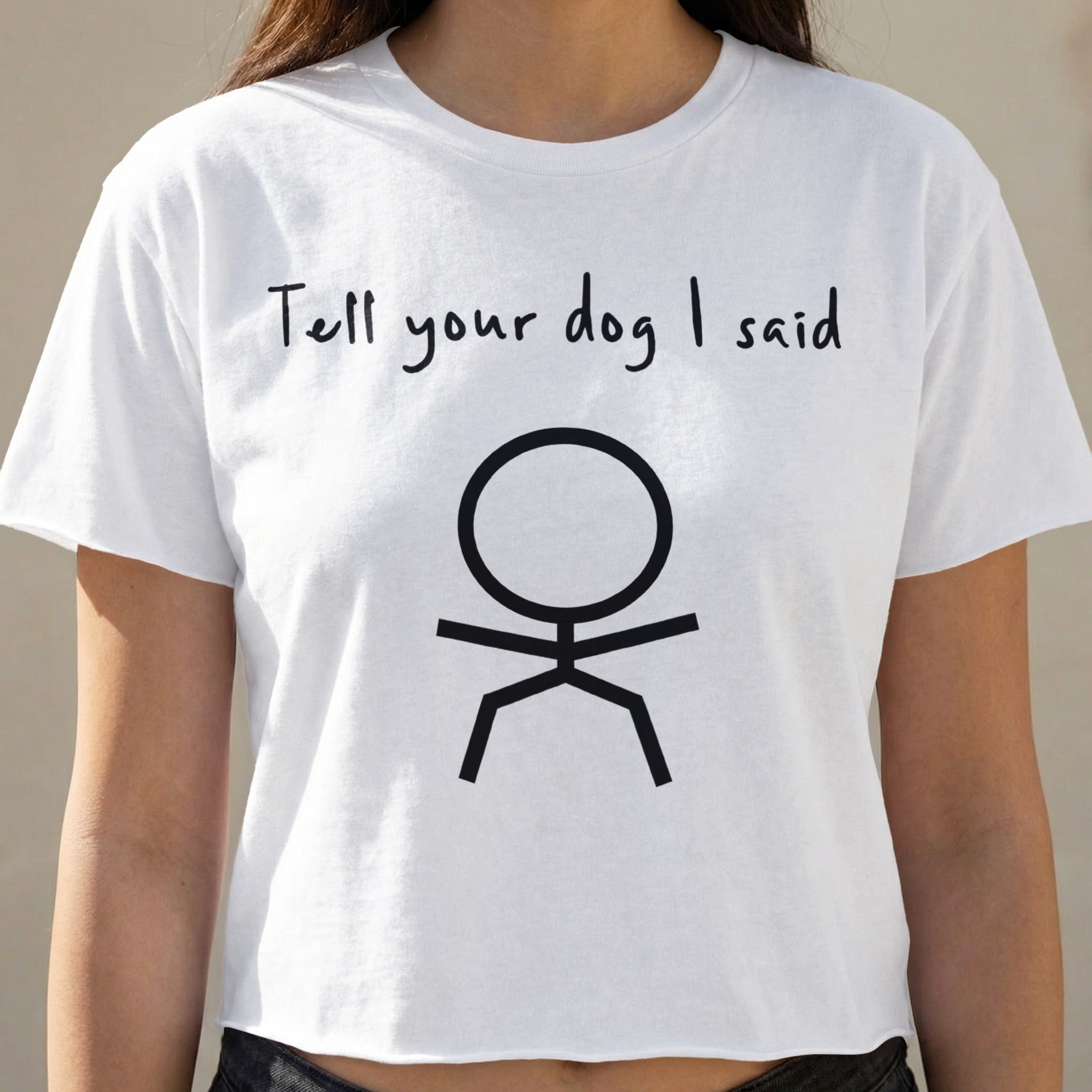 White t-shirt with "Tell your dog I said" and stick figure graphic.