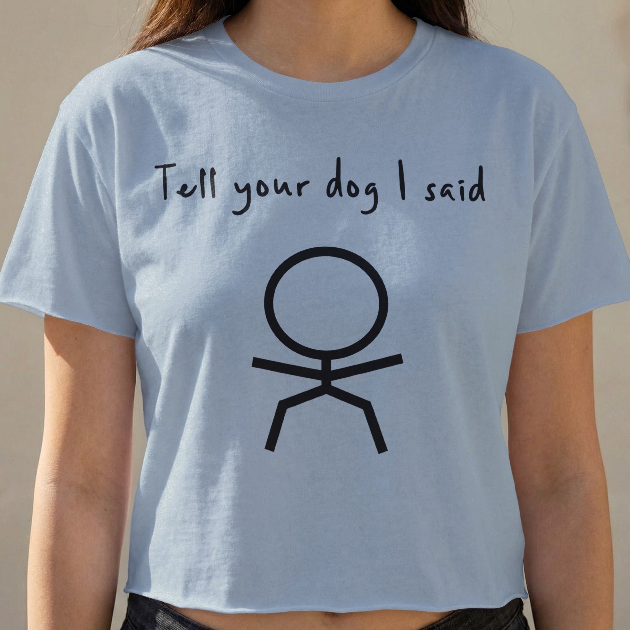 Light blue cropped t-shirt with "Tell your dog I said" and stick figure graphic.