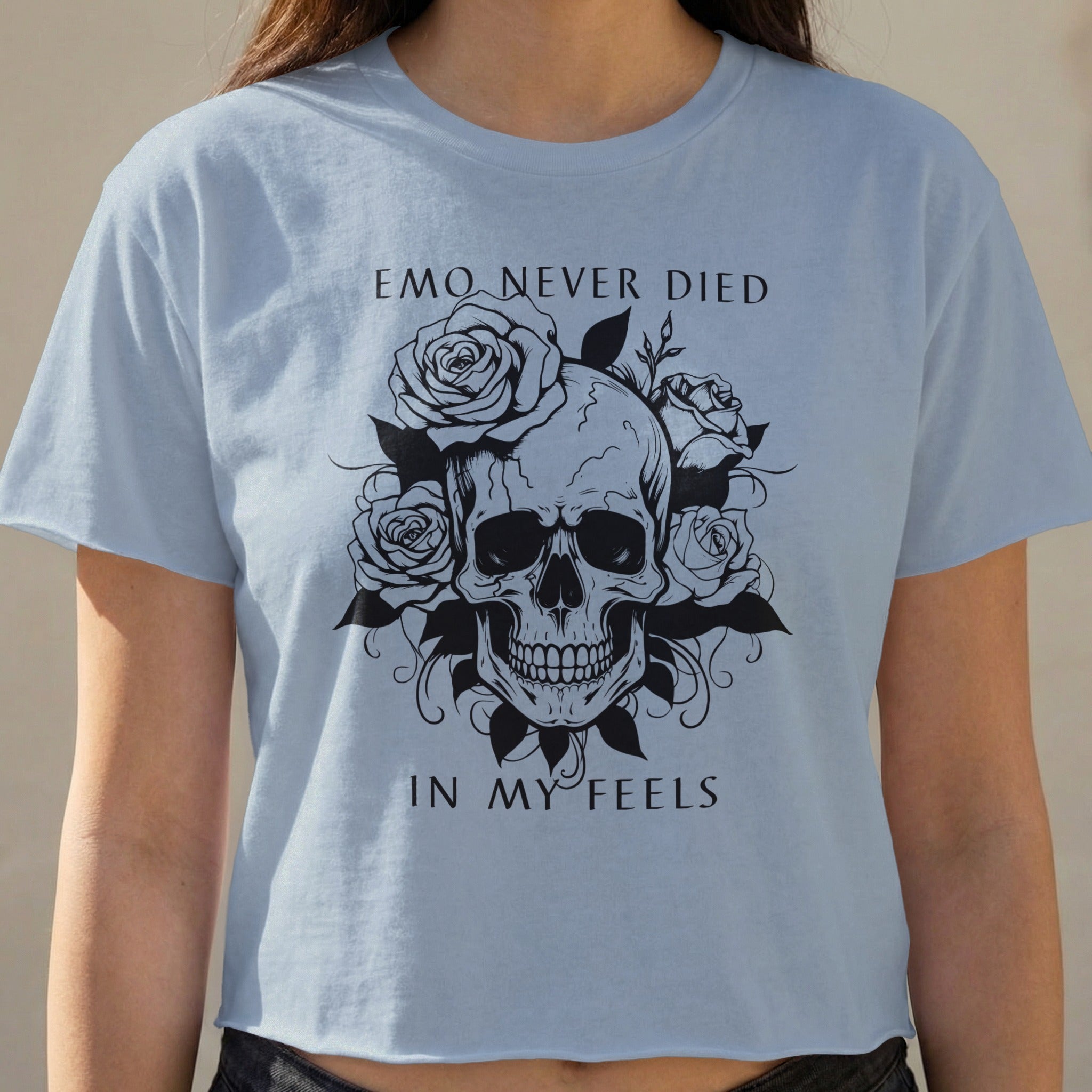 Light blue t-shirt with a black skull and rose graphic and text.