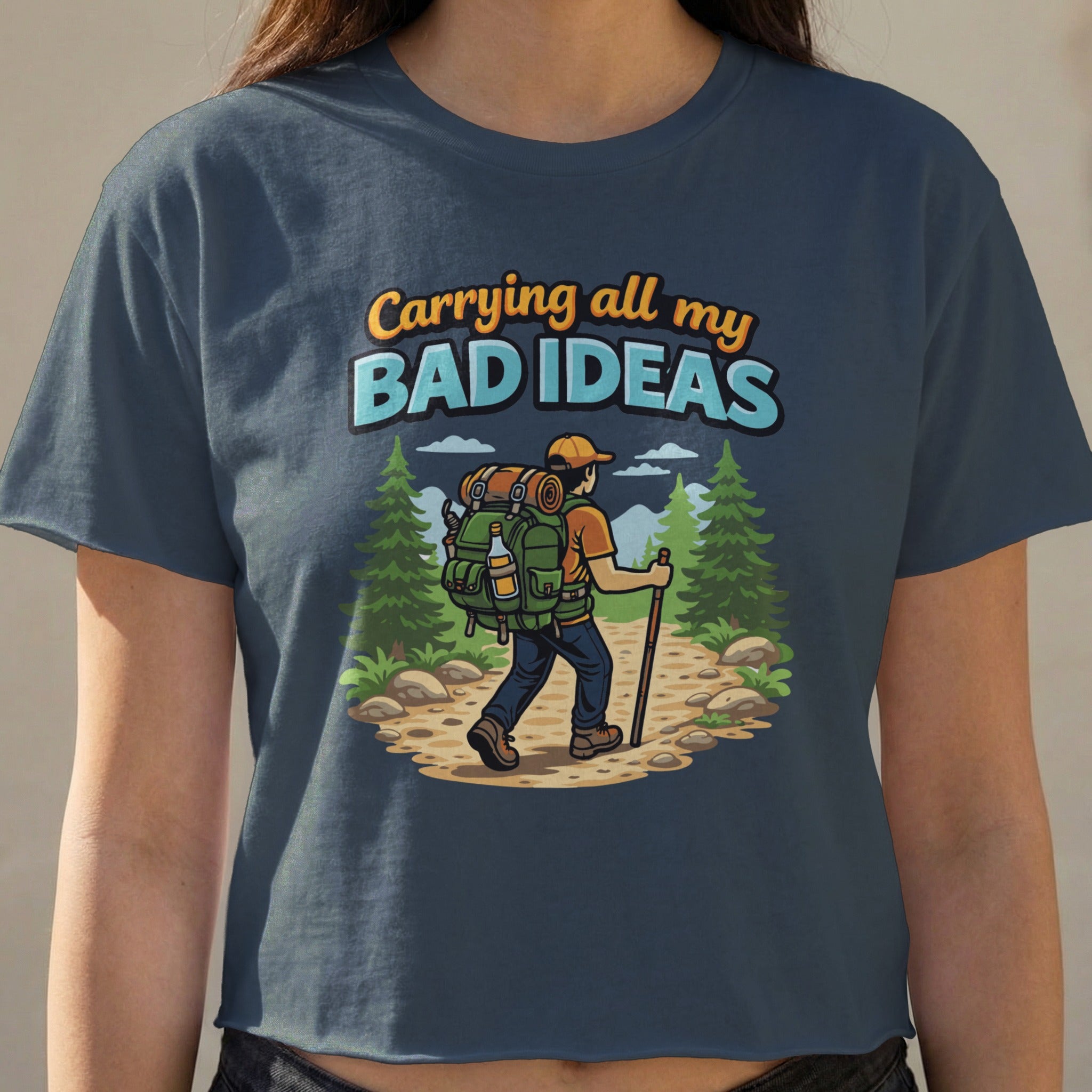 Woman wearing a navy t-shirt with graphic: "Carrying all my bad ideas"
