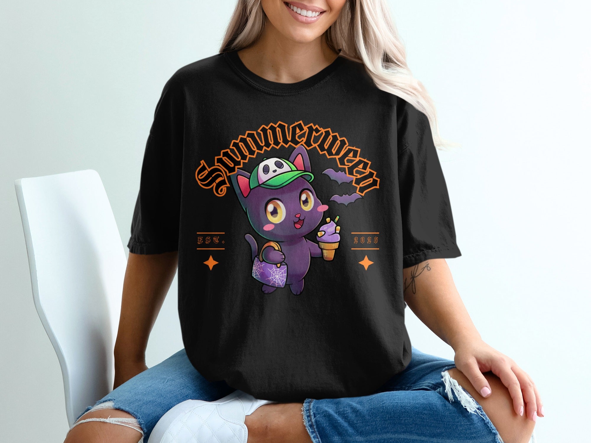Black t-shirt with cartoon cat wearing hat holding ice cream and purse, "Summerween" text.