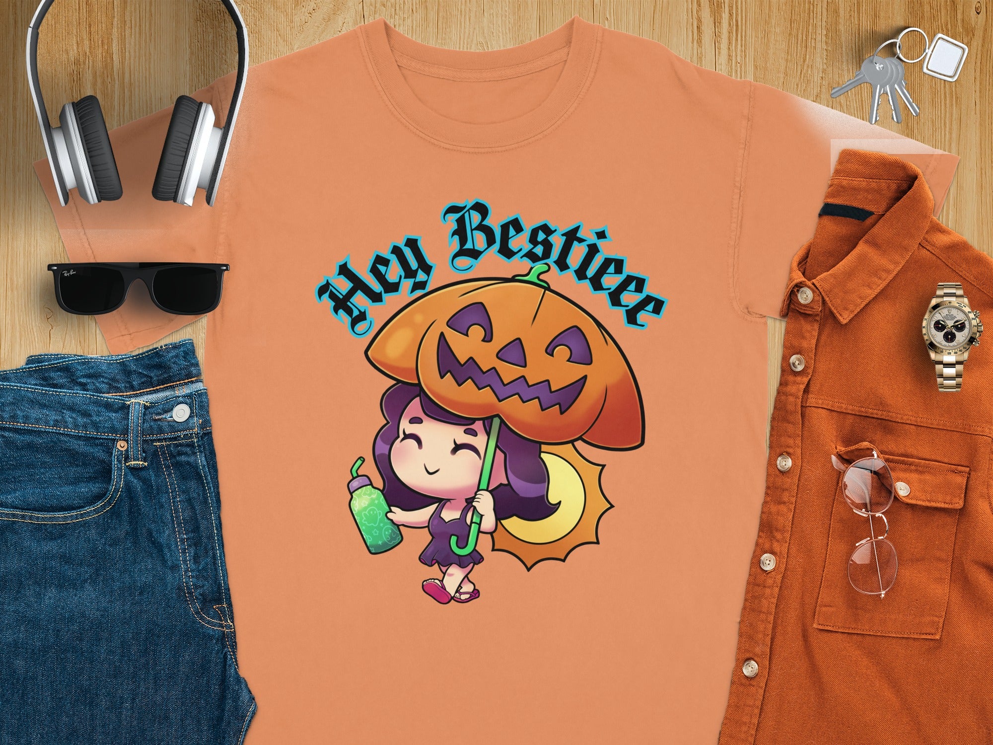 Orange t-shirt with "Hey Bestieee" and a girl holding a pumpkin umbrella.