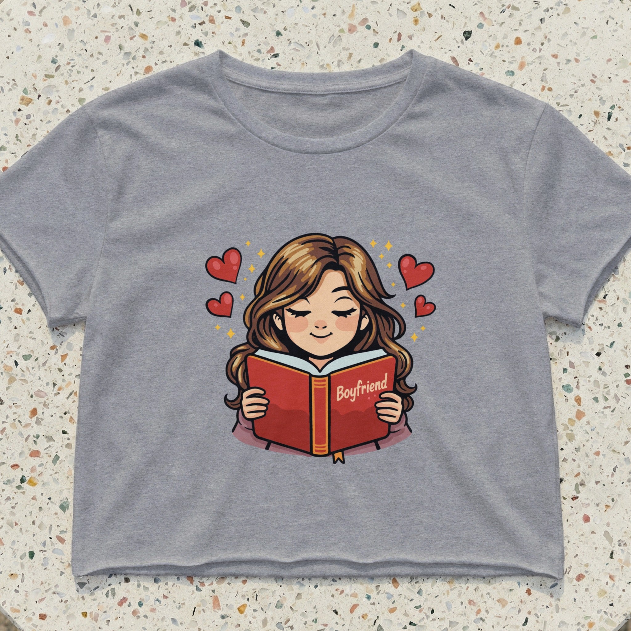 Crop top with illustration of a girl reading a book titled "Boyfriend" with hearts.