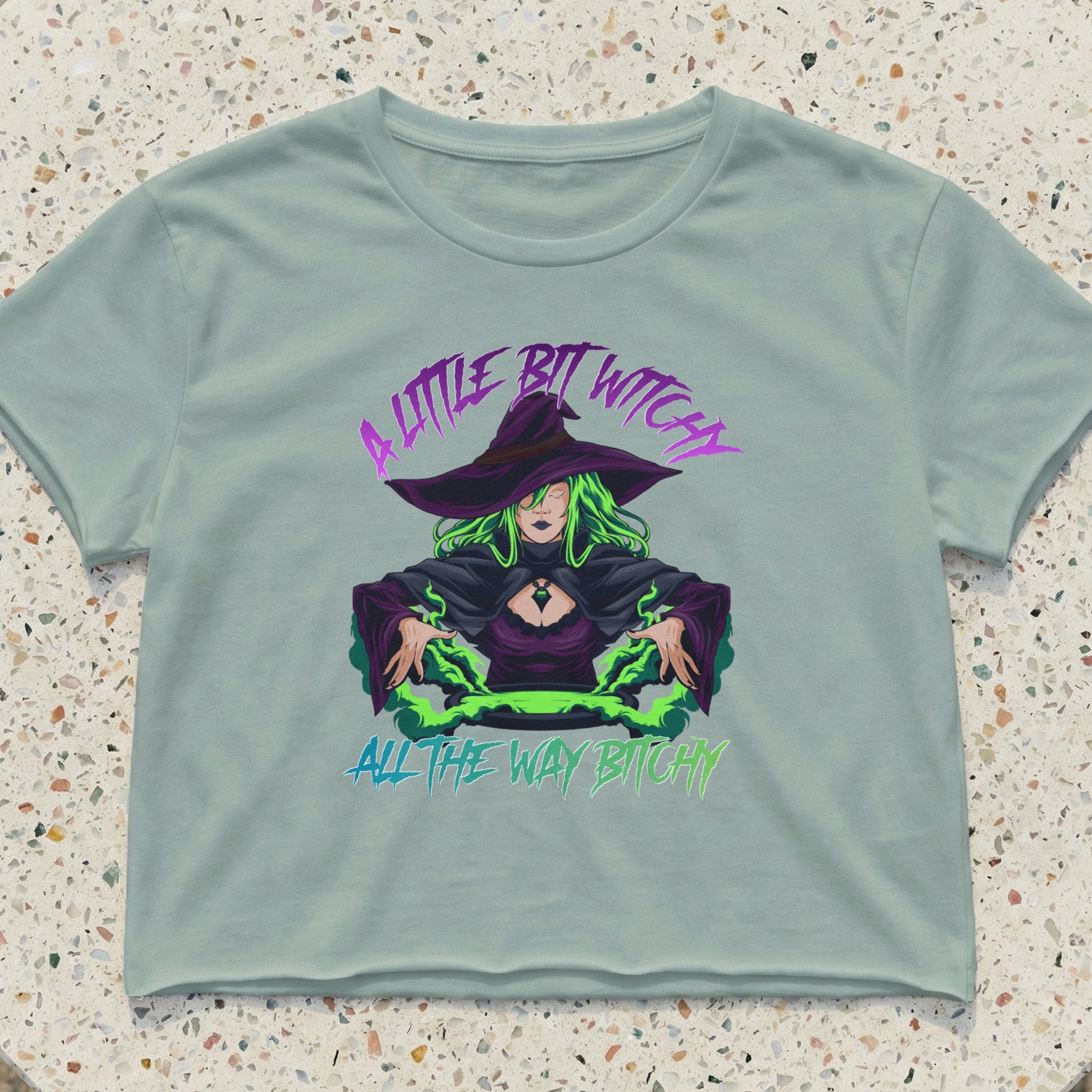 Crop top with a witch graphic and text "A little bit witchy all the way bitchy".