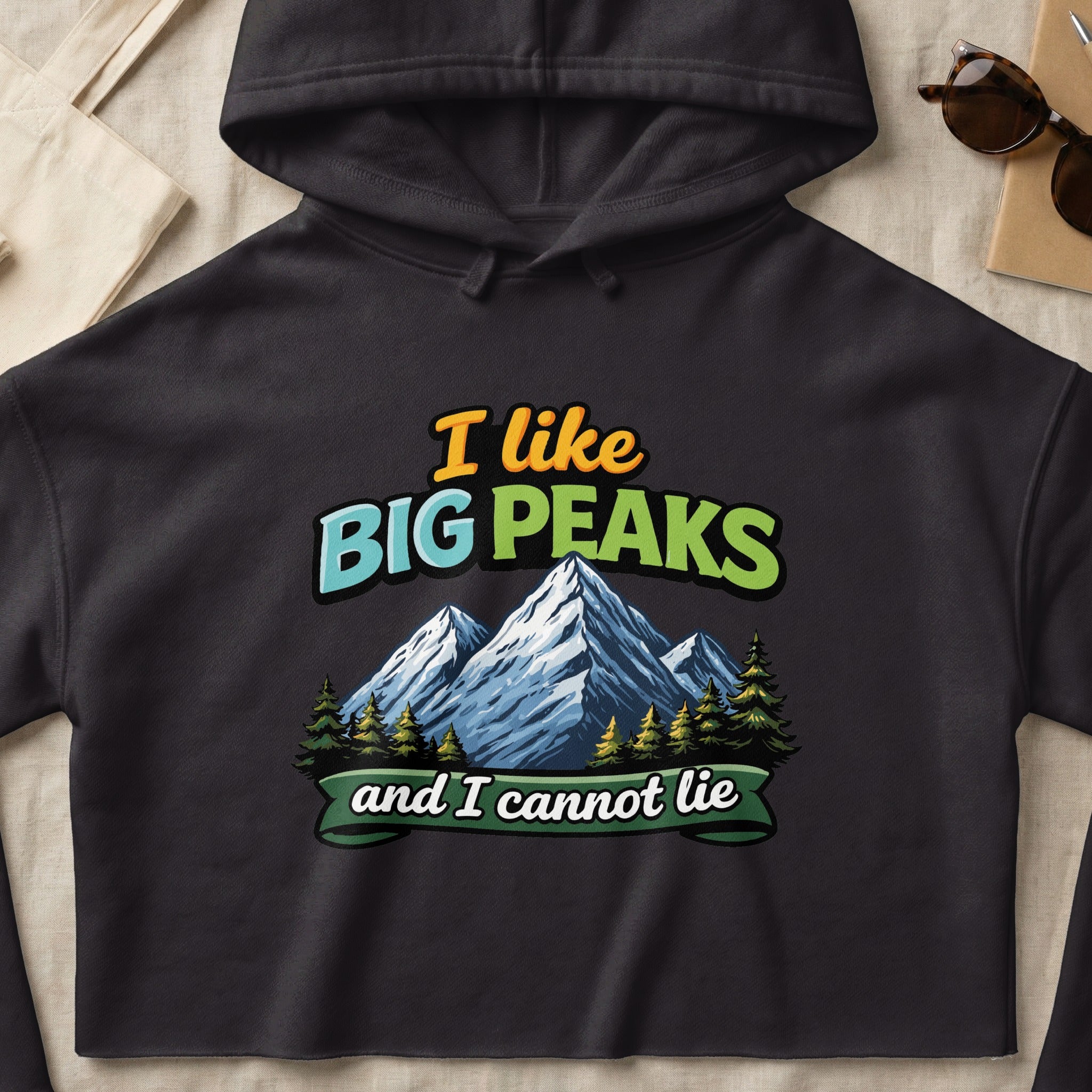 Black hoodie with "I like BIG PEAKS and I cannot lie" text and mountain graphic.
