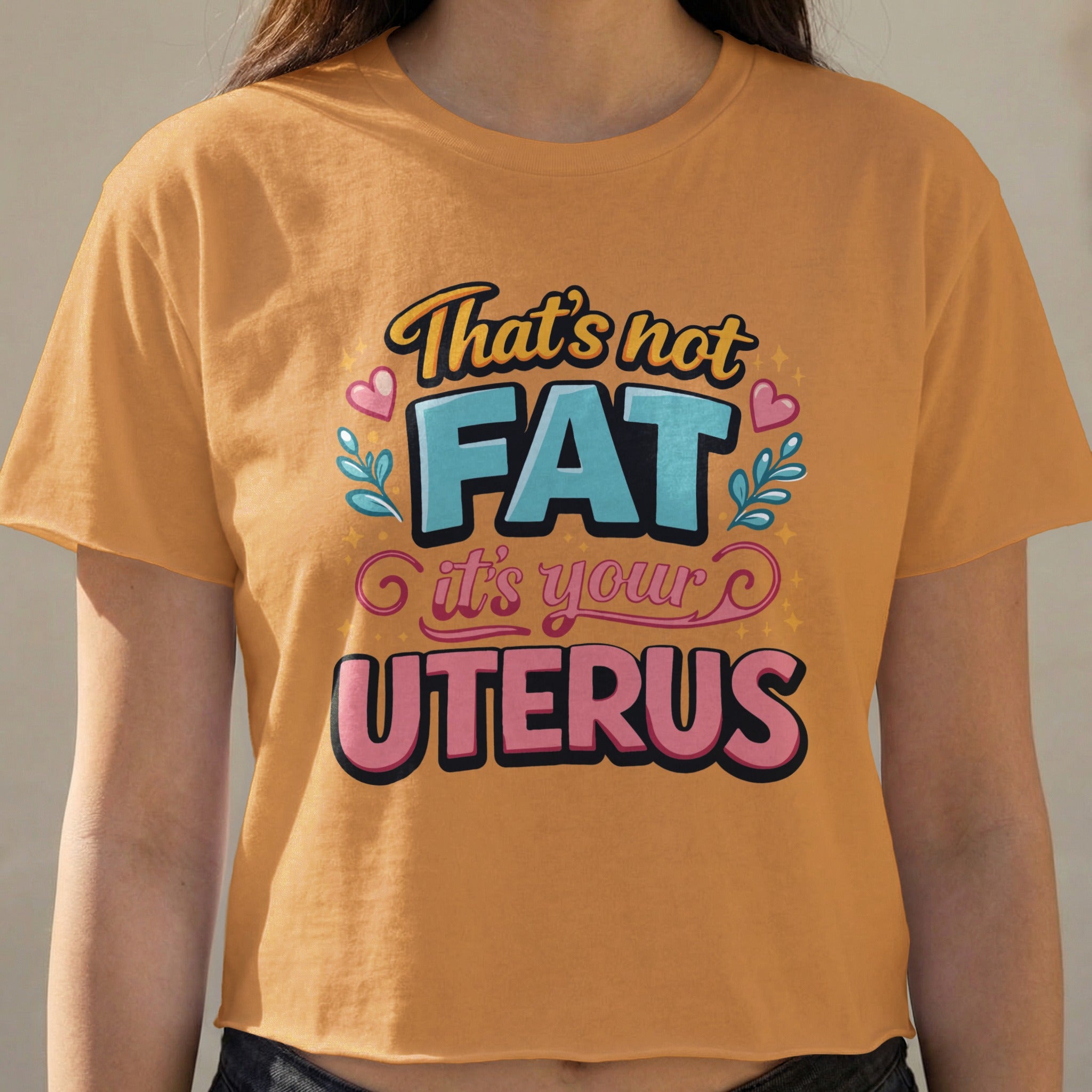 Orange crop top with "That's not FAT it's your UTERUS" text.