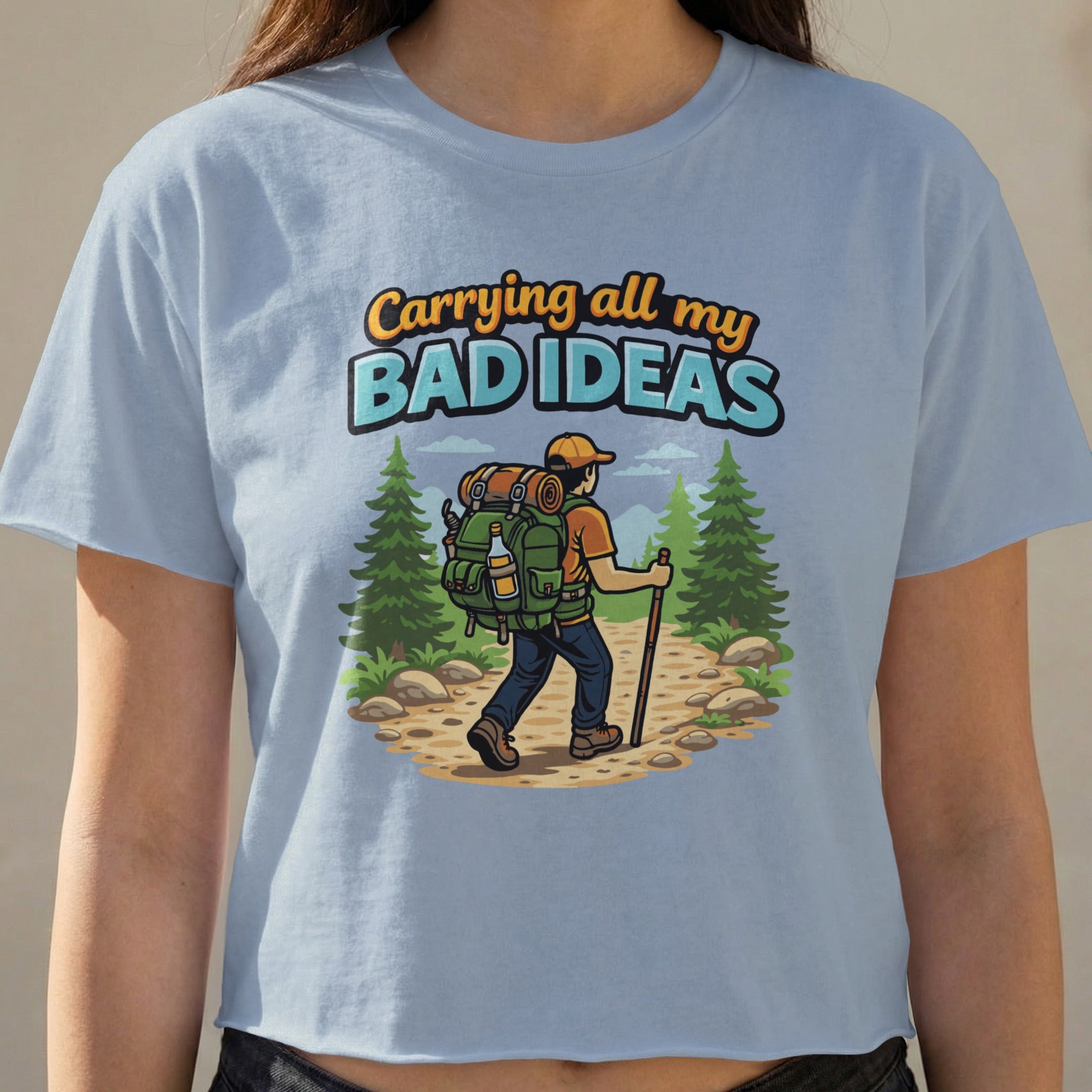 T-shirt with "Carrying all my BAD IDEAS" text and hiker graphic.