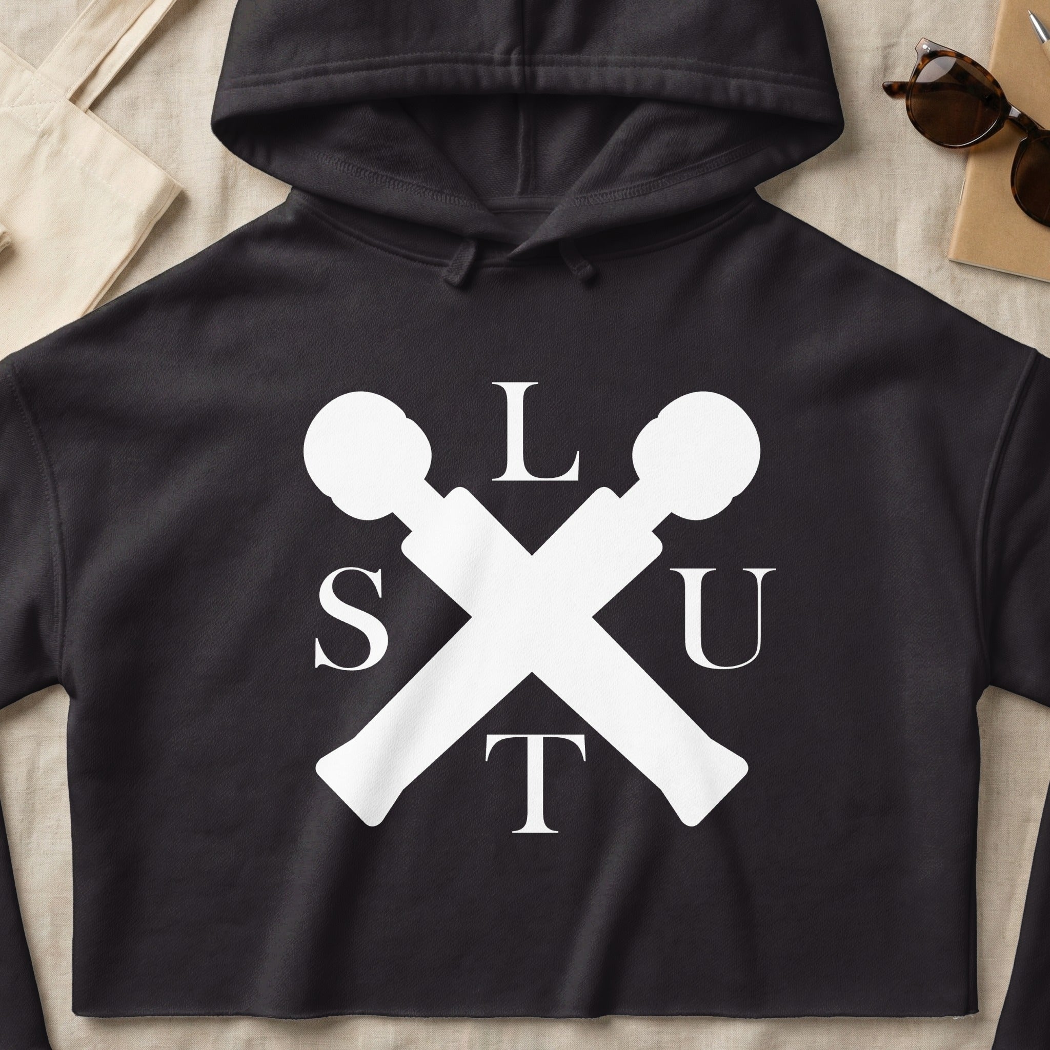 Black cropped hoodie with white "SLUT" logo featuring crossed microphones.