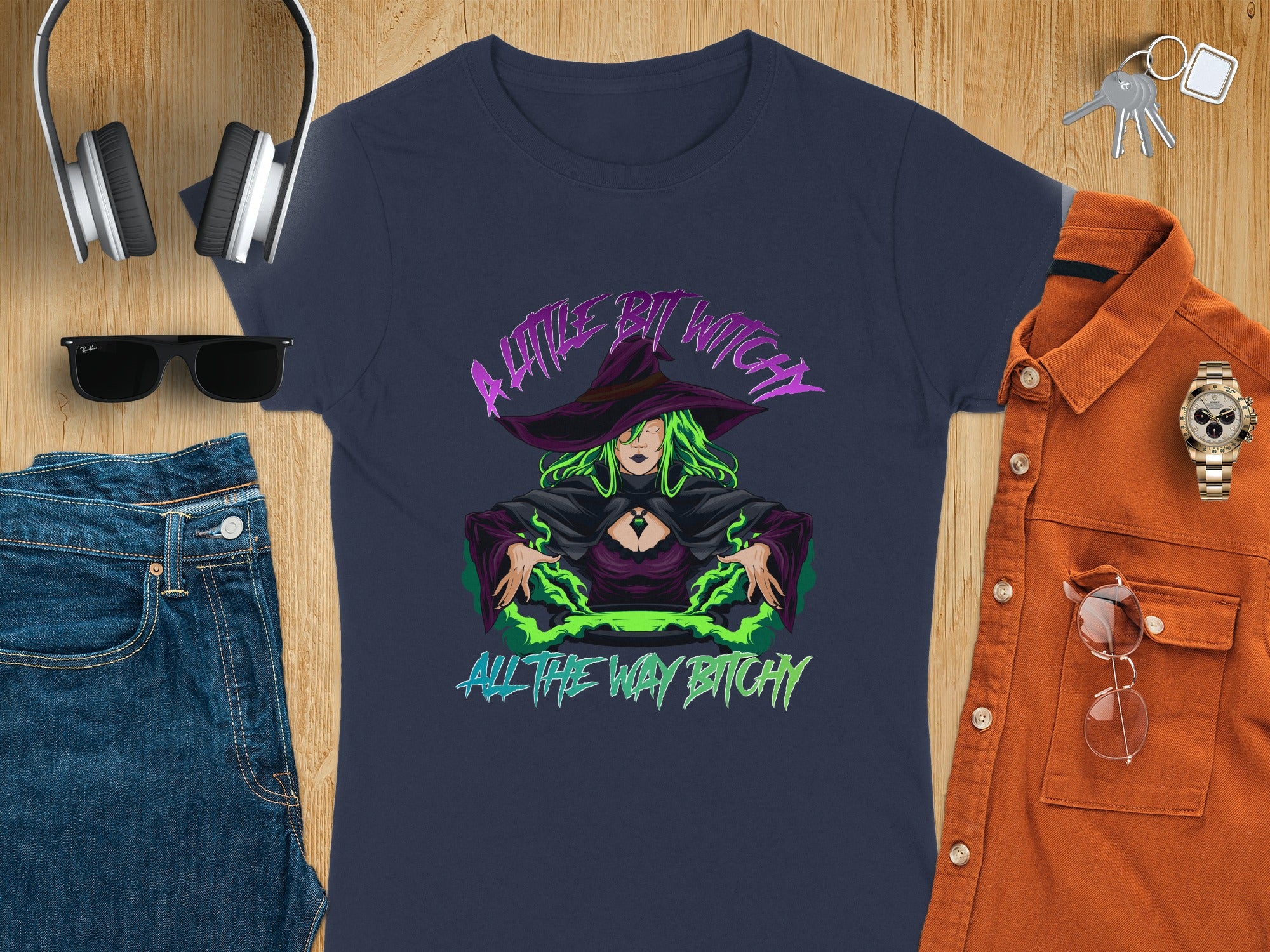 Navy t-shirt with "A Little Bit Witchy All The Way Bitchy" text and witch graphic.