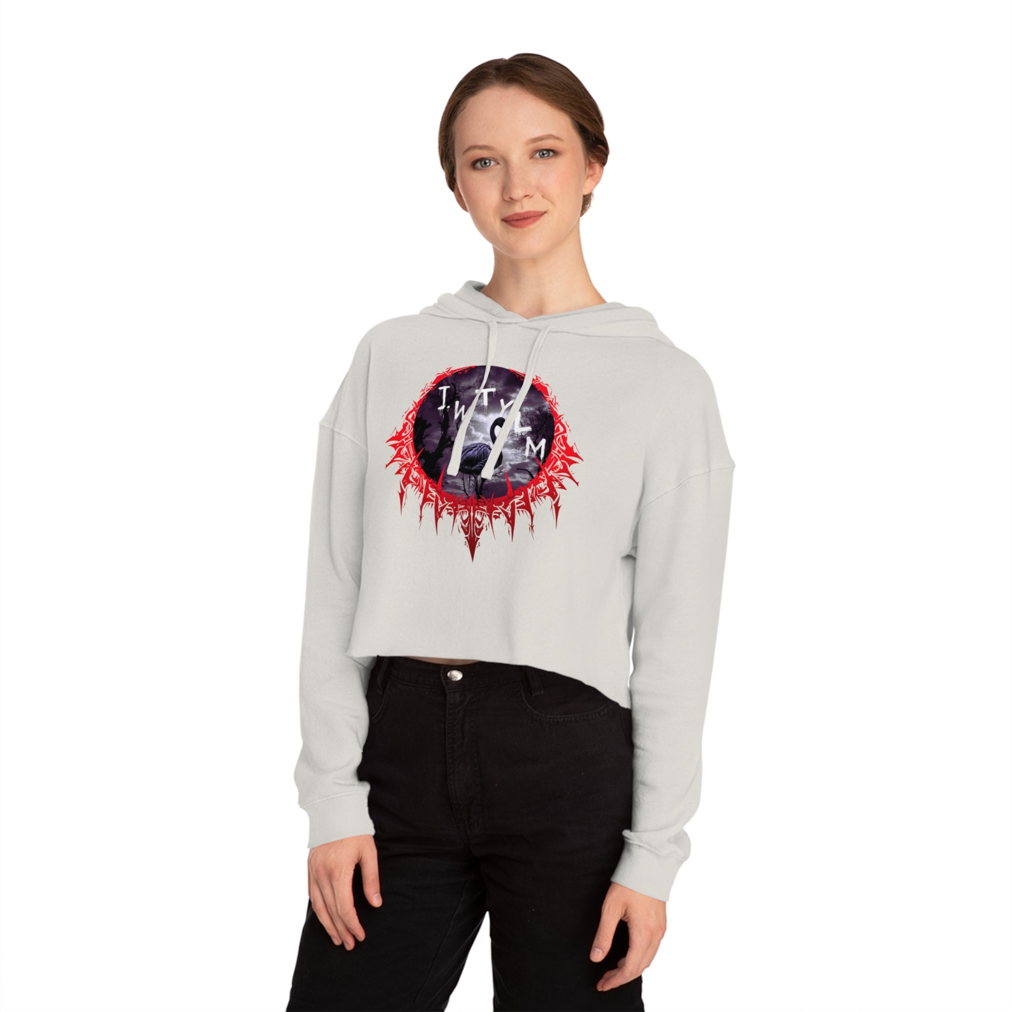 Woman wearing a white cropped hoodie with a red and black graphic logo.