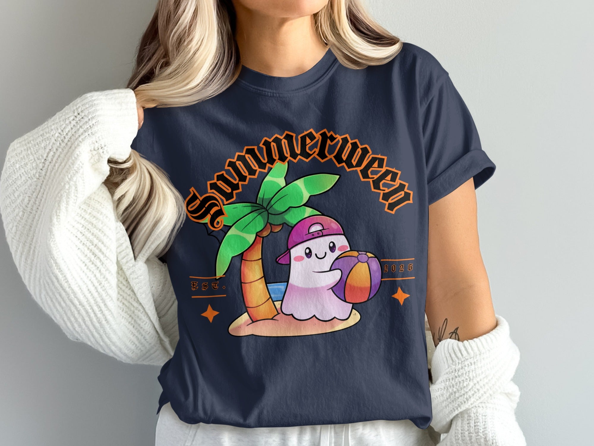 "Summerween" t-shirt with a ghost holding a beach ball under a palm tree.