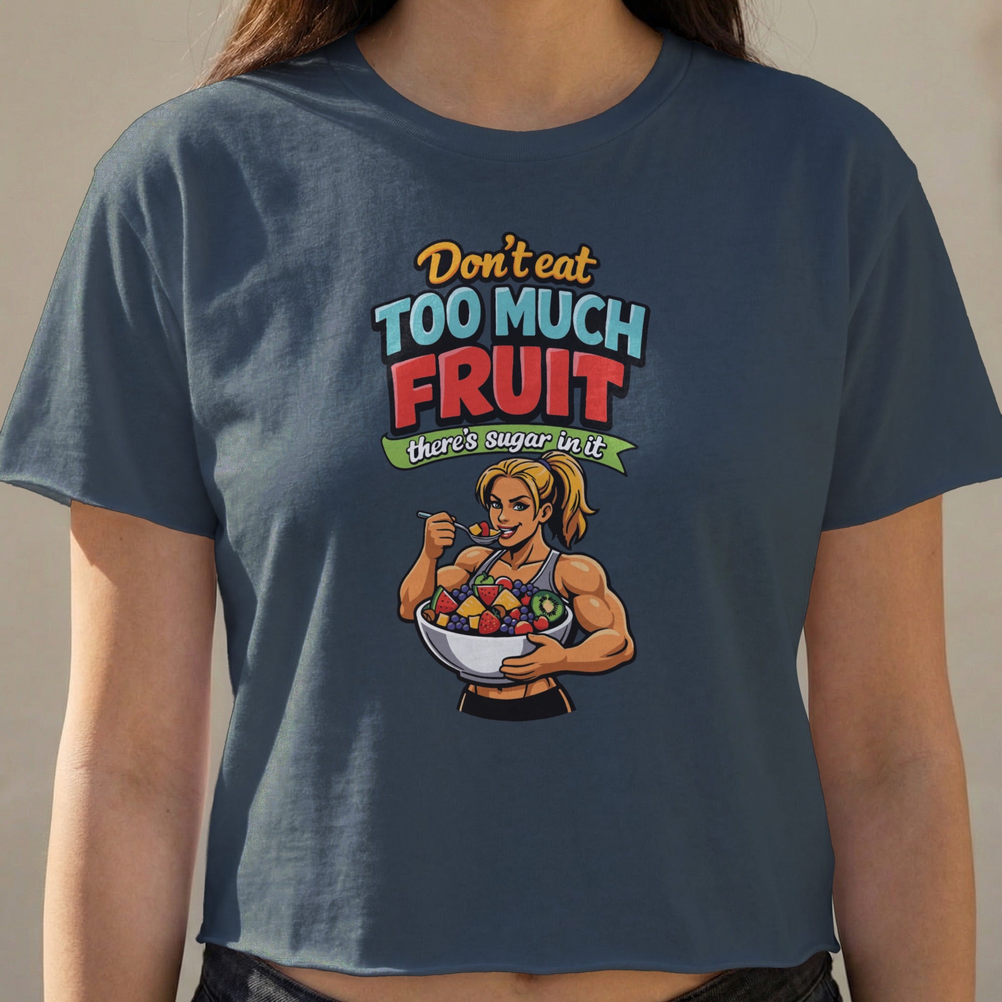 T-shirt with graphic of fit woman eating fruit, text "Don't eat too much fruit, there's sugar in it."
