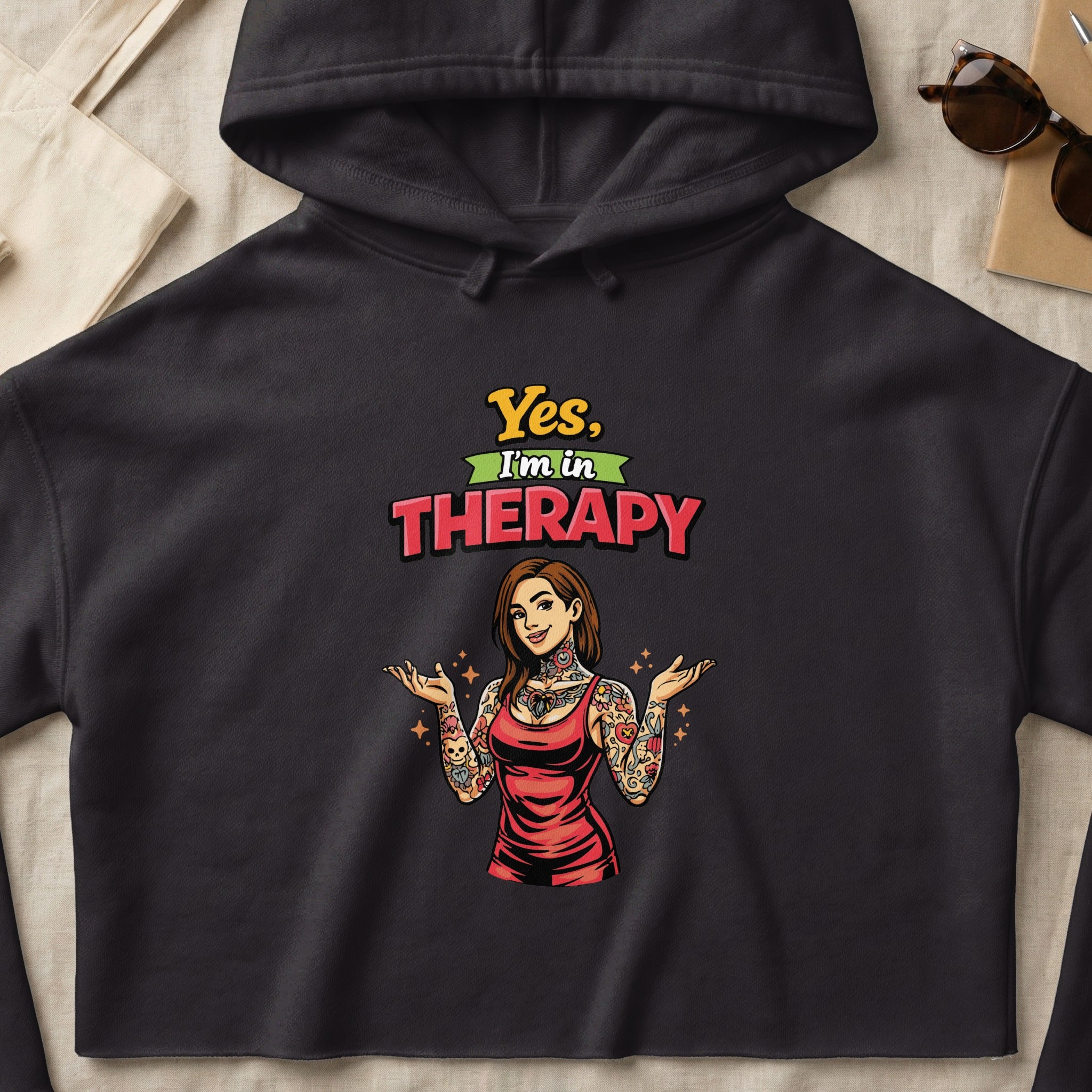 Black hoodie with "Yes, I'm in Therapy" text and tattooed woman graphic.