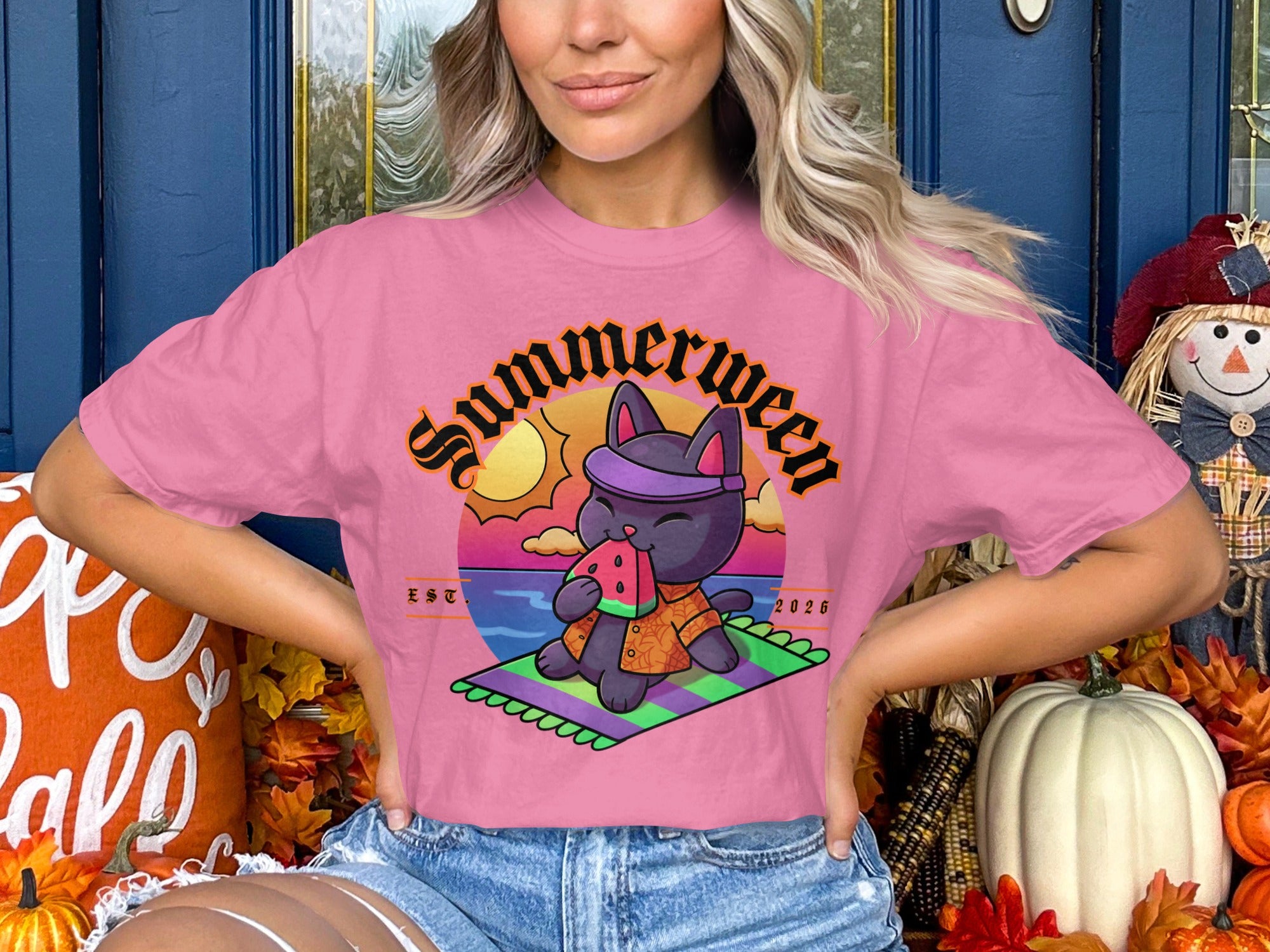 Pink t-shirt with graphic of a cat eating watermelon with text "Summerween EST. 2026".