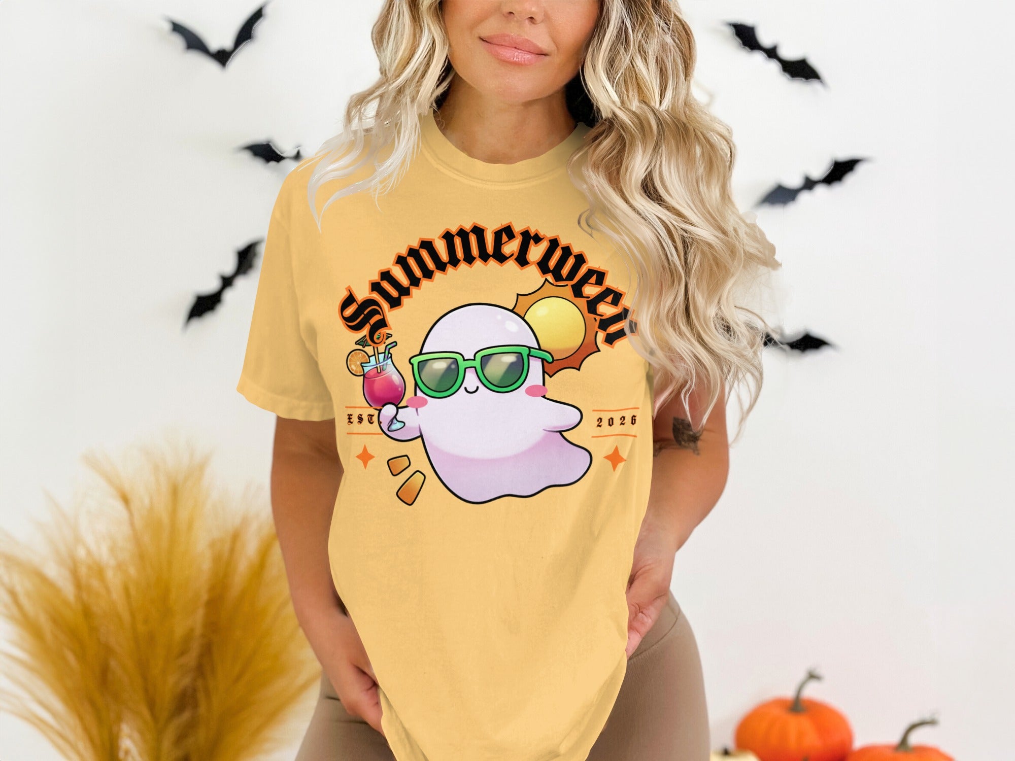 Yellow t-shirt with a cute ghost wearing sunglasses and holding a drink, with "Summerween EST 2026" text.