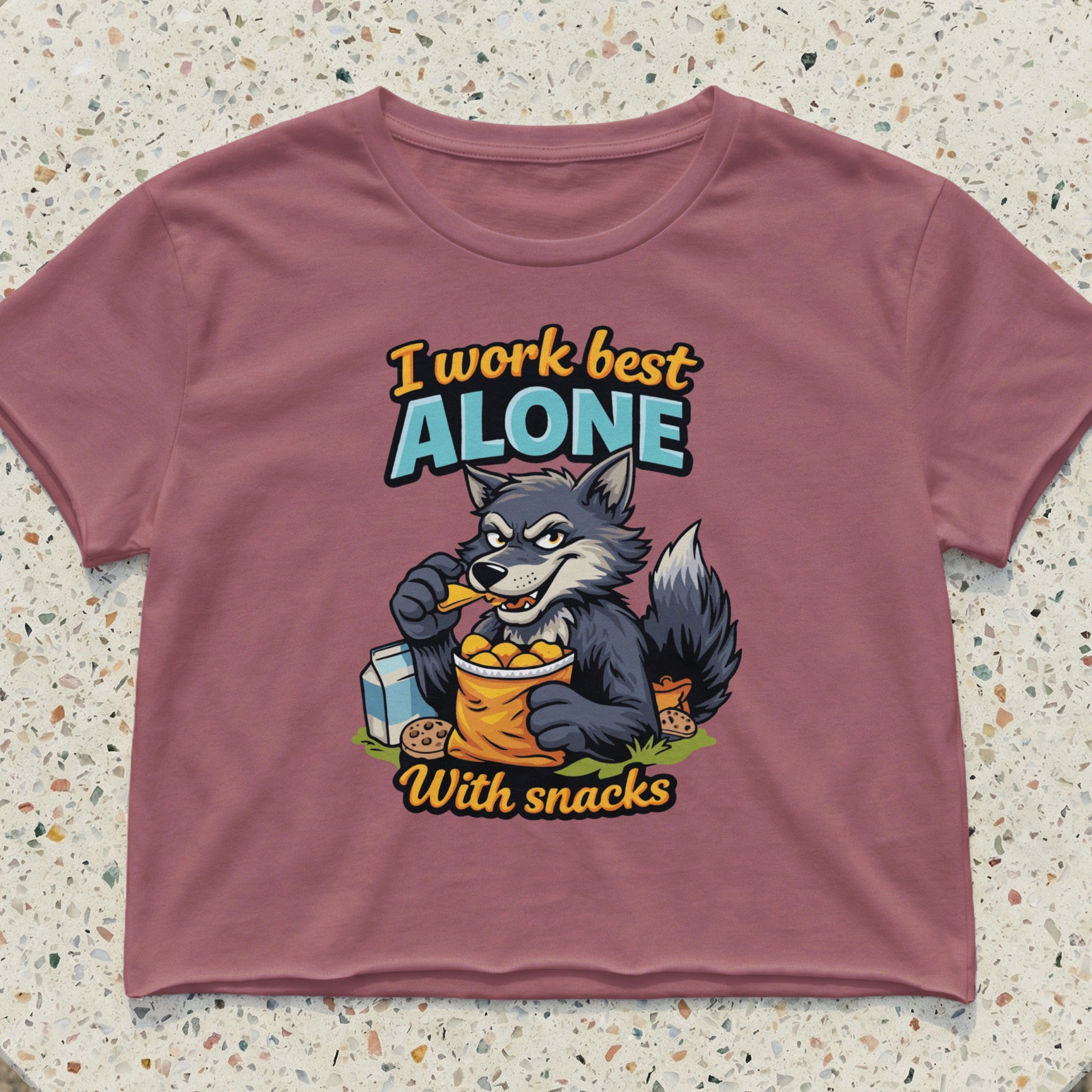 Wolf eating snacks from bag with text "I work best alone".