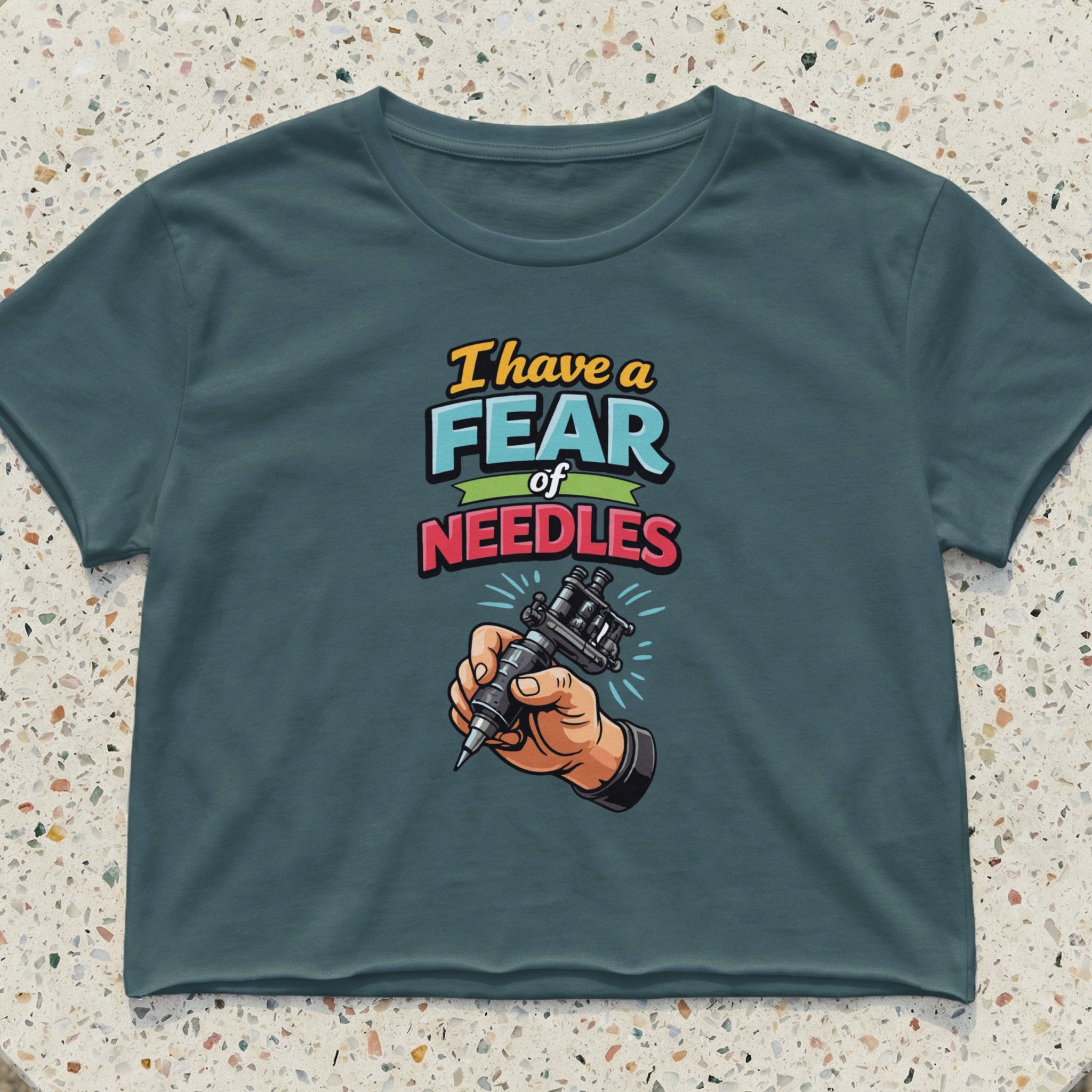 Cropped t-shirt with "I have a fear of NEEDLES" and a hand holding a tattoo gun.