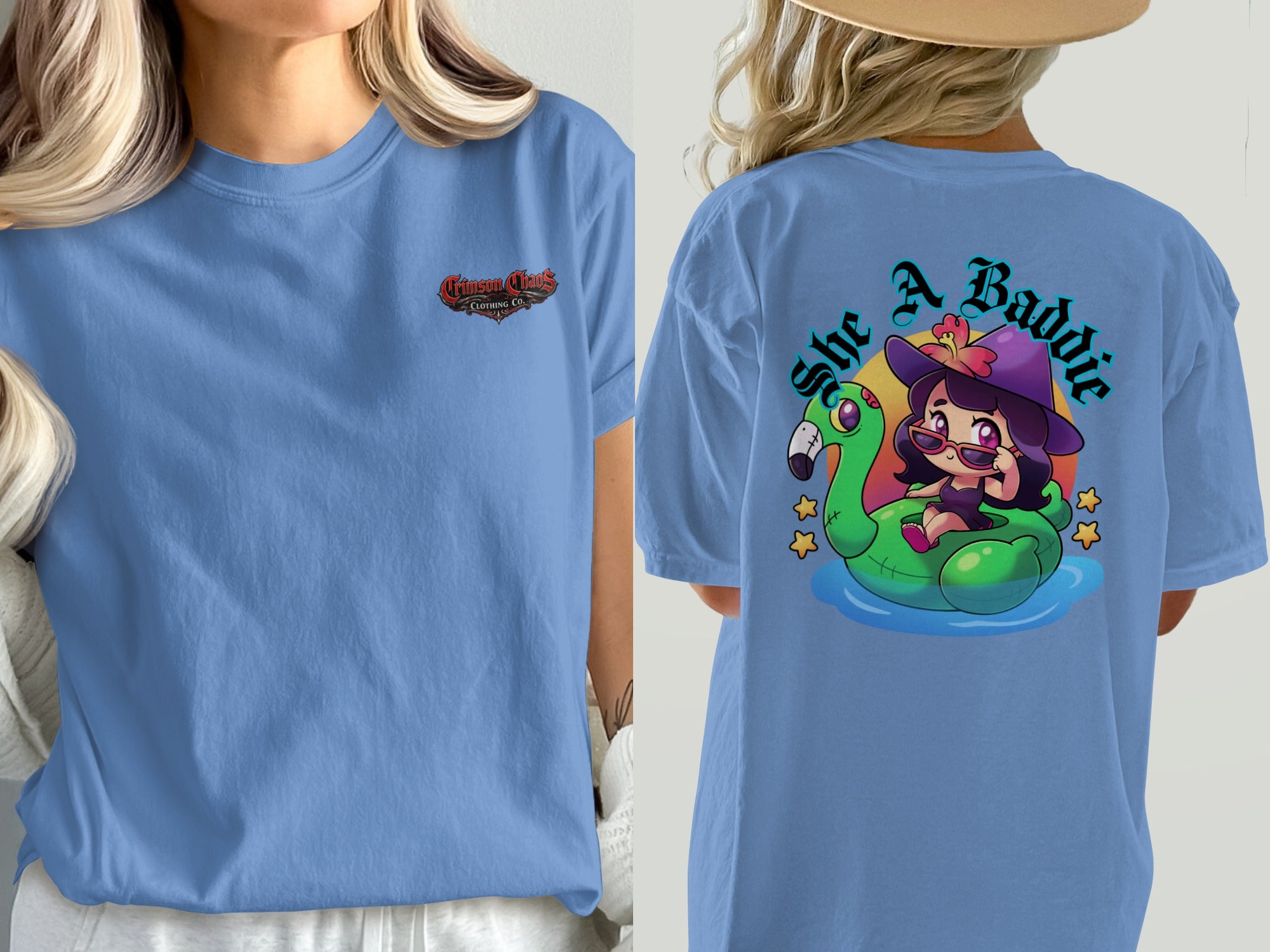 Blue t-shirt with "Crimson Chaos Clothing Co." on front and cartoon witch on flamingo float with "She A Baddie" on back.