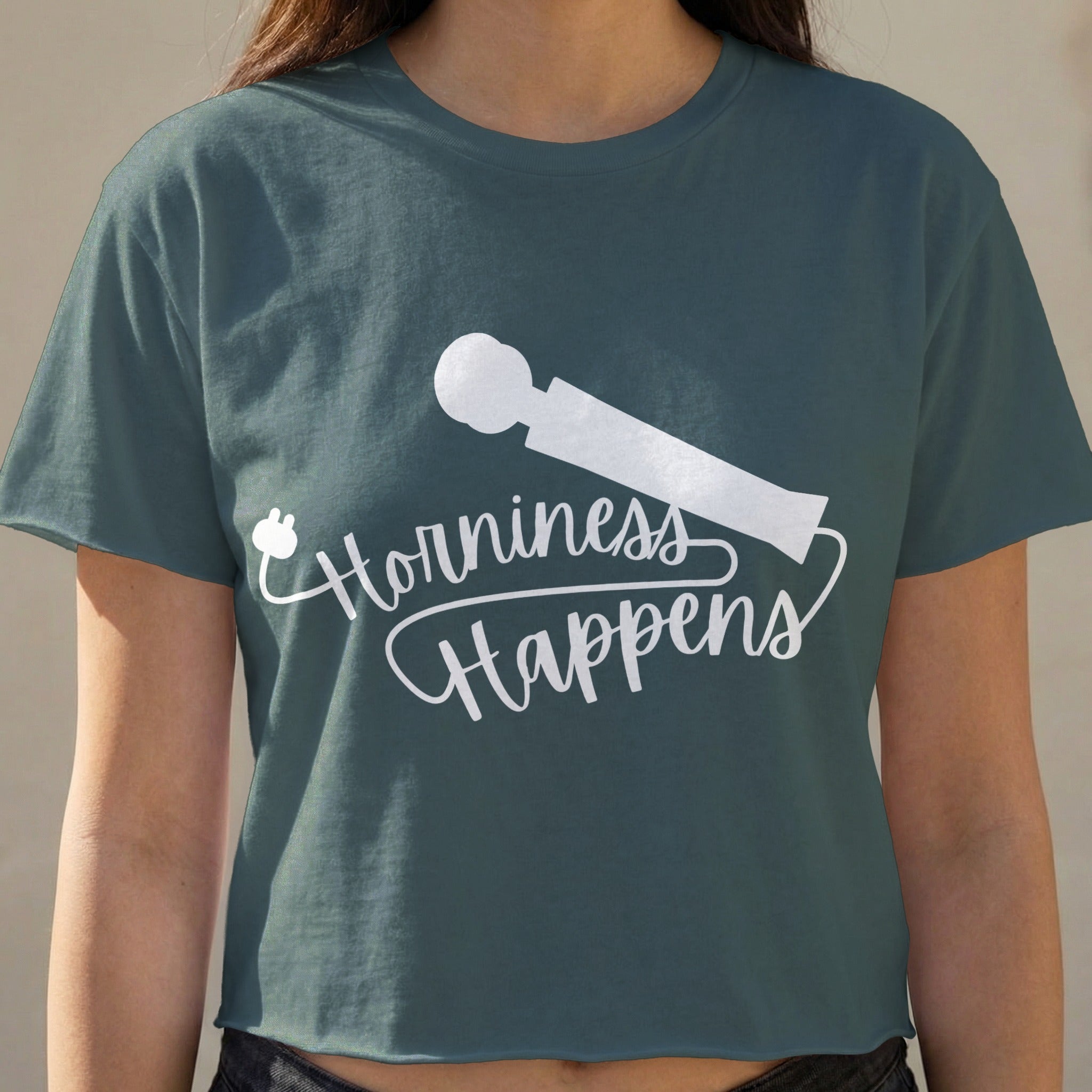 Cropped dark teal t-shirt with "Horniness Happens" and a white vibrating wand graphic.